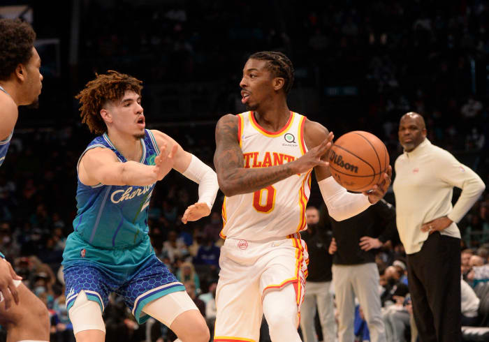 Jan 23, 2022; Charlotte, North Carolina, USA; Atlanta Hawks guard Delon Wright (0) looks to pass as he is defended by Charlotte Hornets guard LaMelo Ball (2) during the first half against the Charlotte Hornets at The Spectrum Center.